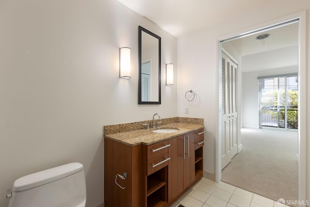 bathroom featuring tile patterned floors, vanity, and toilet