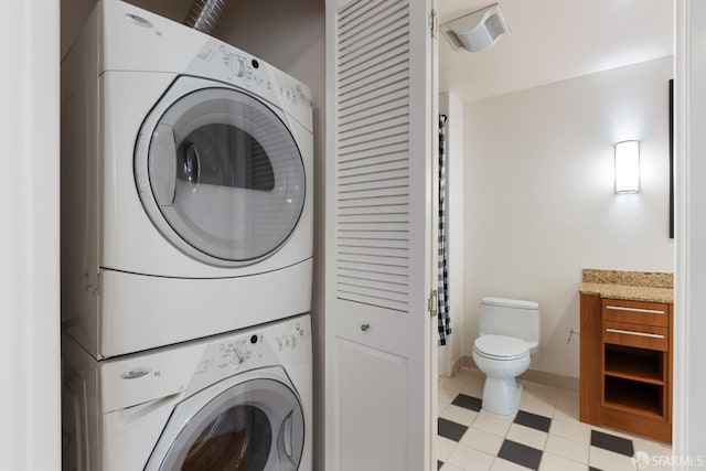 laundry room with stacked washing maching and dryer