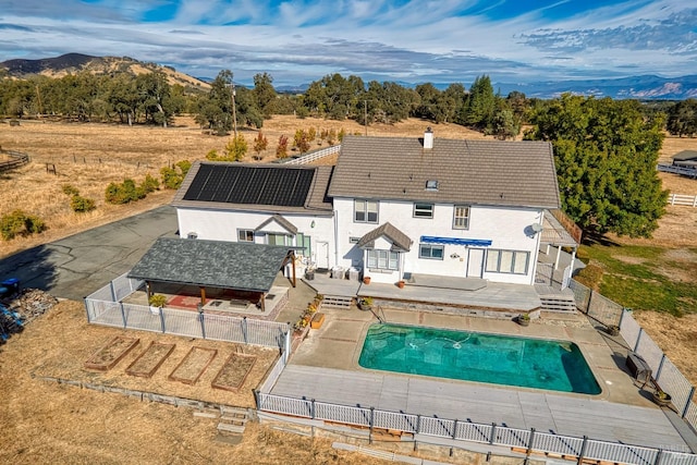 back of house with a patio, a gazebo, and a pool side deck with mountain view