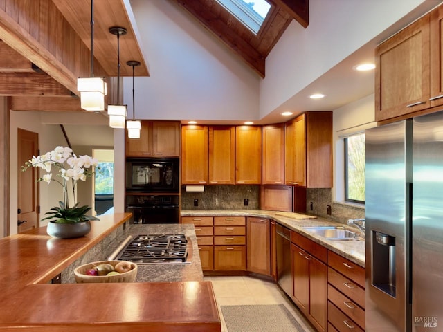33755 Yardarm Dr Unit 15-1, The Sea Ranch, CA 95497 - kitchen featuring black appliances, a skylight, brown cabinets, beamed ceiling, and high vaulted ceiling