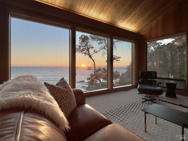 sunroom / solarium with wood ceiling, a water view, and vaulted ceiling