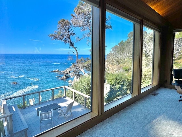 unfurnished sunroom with a water view and wood ceiling