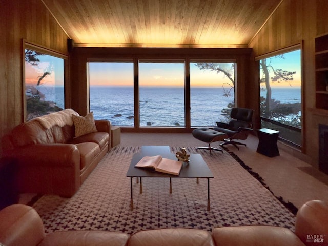 33755 Yardarm Dr Unit 15-1, The Sea Ranch, CA 95497 - living room with lofted ceiling, carpet, wood walls, a water view, and wooden ceiling