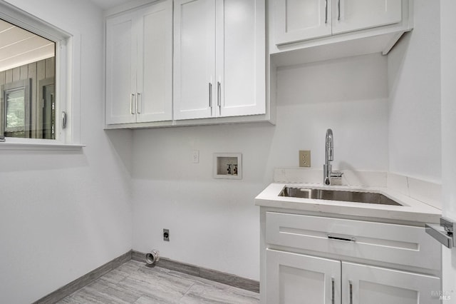 clothes washing area with sink, washer hookup, cabinets, and electric dryer hookup