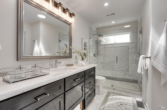 bathroom with toilet, a shower with shower door, and vanity