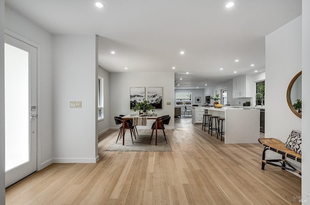 dining room with light wood-type flooring and sink