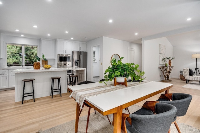 dining space with light hardwood / wood-style flooring