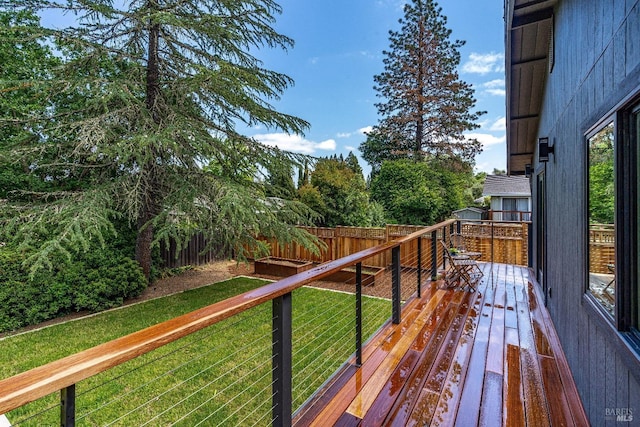 wooden terrace with a lawn