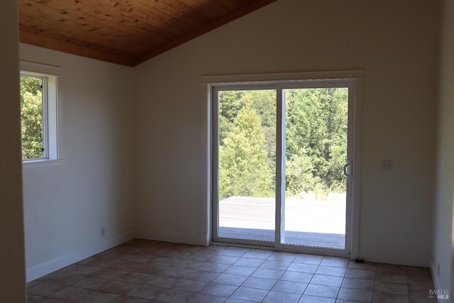 empty room featuring lofted ceiling, a healthy amount of sunlight, wooden ceiling, and light tile patterned floors