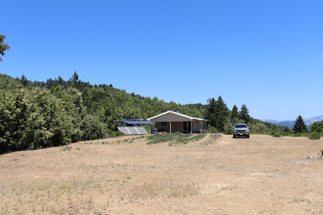 view of yard with an outdoor structure and a rural view