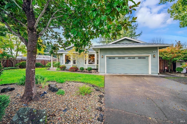 ranch-style house with a garage and a front lawn