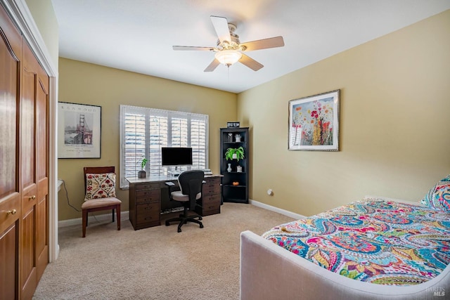 carpeted bedroom with ceiling fan and a closet