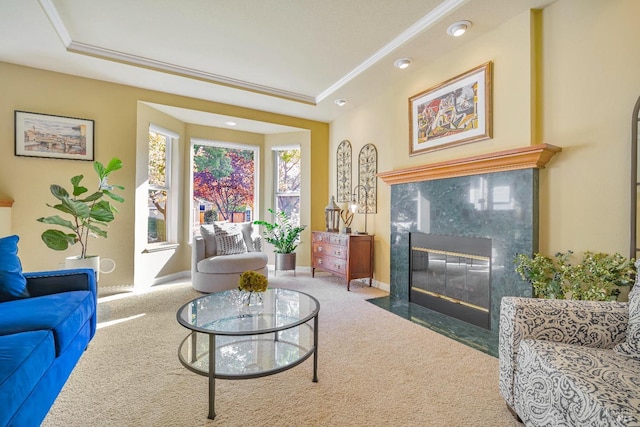 carpeted living room with a raised ceiling, crown molding, and a high end fireplace