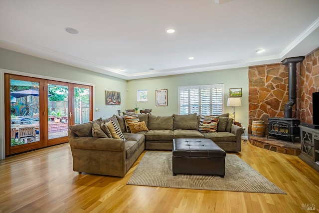 living room with light wood-type flooring and a wood stove