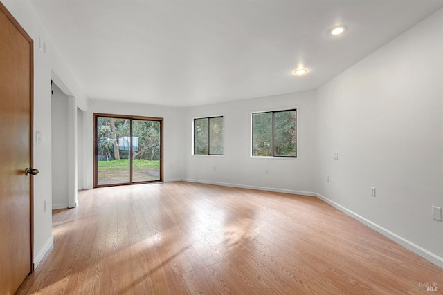 spare room featuring light wood-type flooring