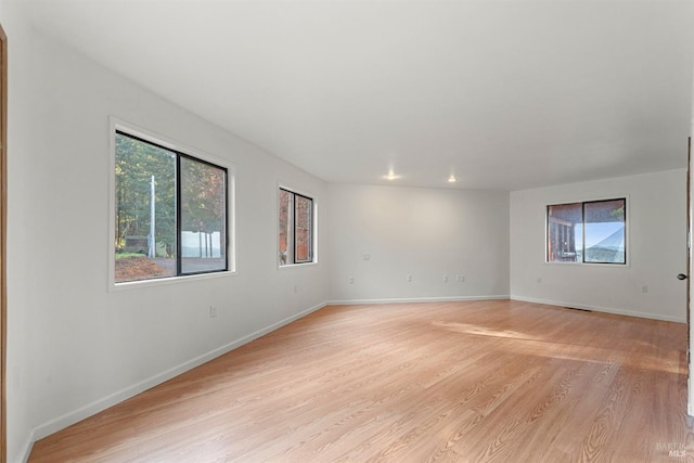 empty room with light hardwood / wood-style flooring