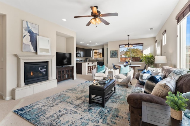 carpeted living room featuring ceiling fan