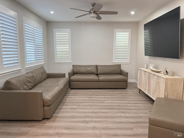 living room featuring ceiling fan and light wood-type flooring