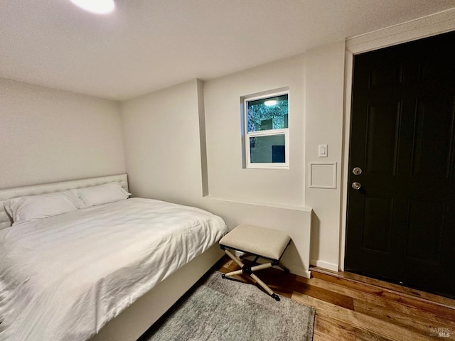 bedroom with wood finished floors