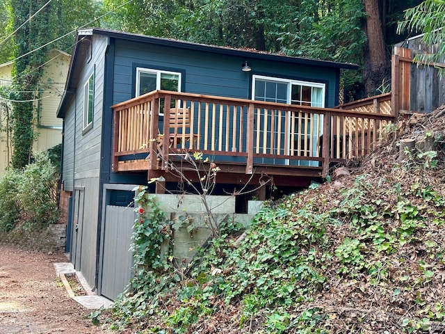 rear view of property featuring a wooden deck