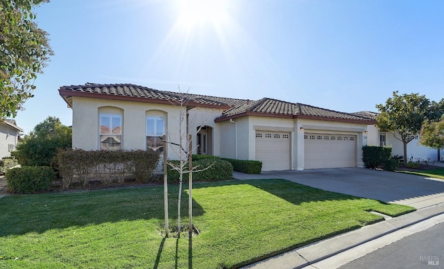 mediterranean / spanish-style house with an attached garage, concrete driveway, a tiled roof, stucco siding, and a front lawn