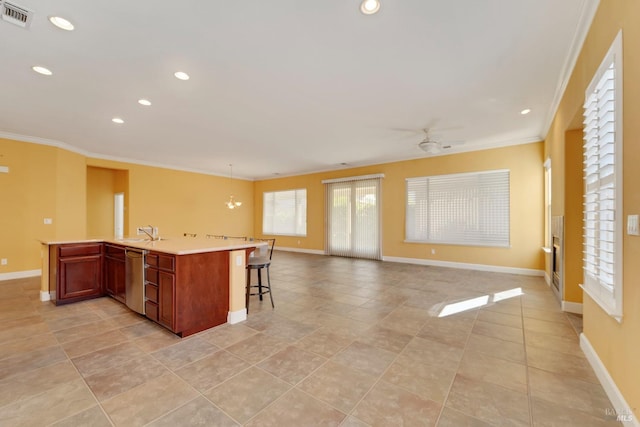 kitchen with open floor plan, visible vents, ornamental molding, and baseboards