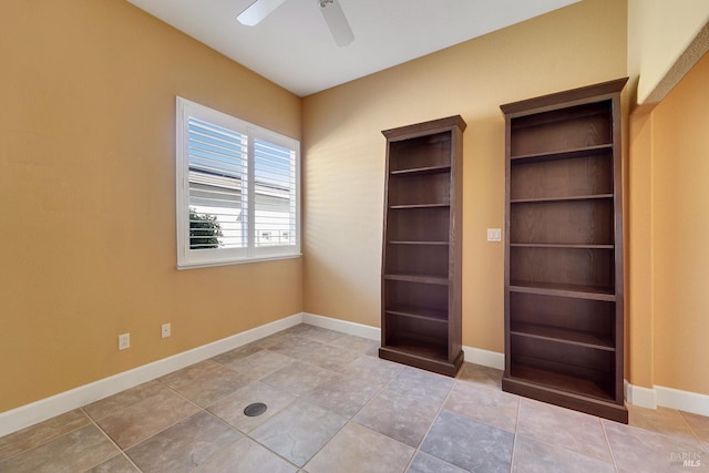 interior space featuring ceiling fan and baseboards