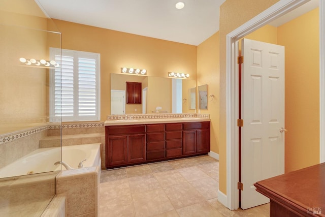 full bath with tile patterned floors, a garden tub, a sink, and double vanity