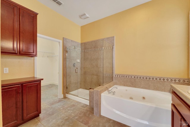 bathroom featuring a bath, visible vents, tile patterned flooring, a shower stall, and vanity