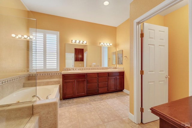 full bathroom with double vanity, tile patterned floors, a sink, and a bath