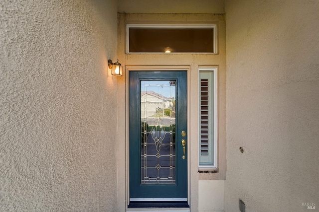 entrance to property with stucco siding