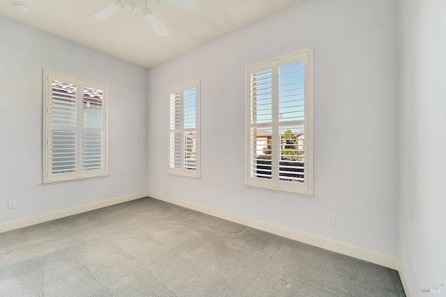 spare room featuring carpet floors, baseboards, and a ceiling fan