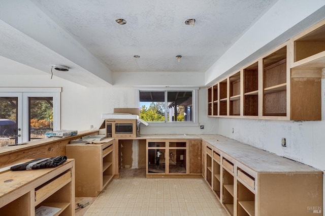 interior space featuring a wealth of natural light and a textured ceiling