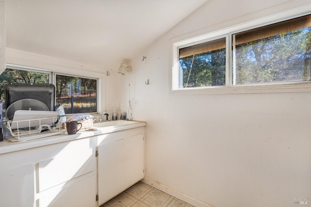 bathroom featuring vaulted ceiling