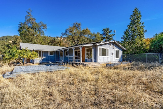 back of property with a wooden deck