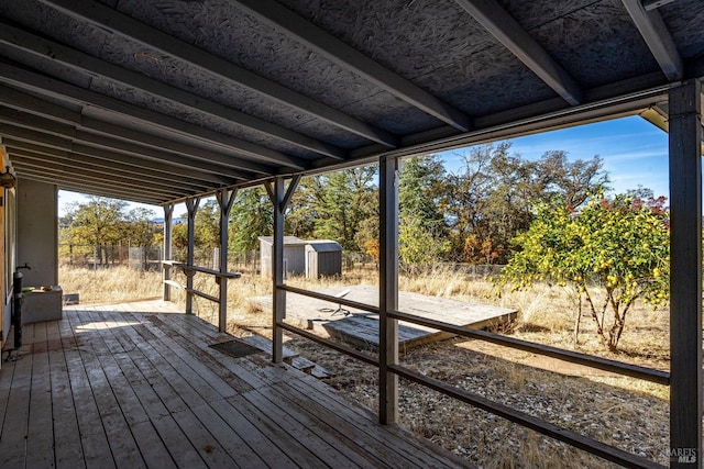 wooden terrace with a shed