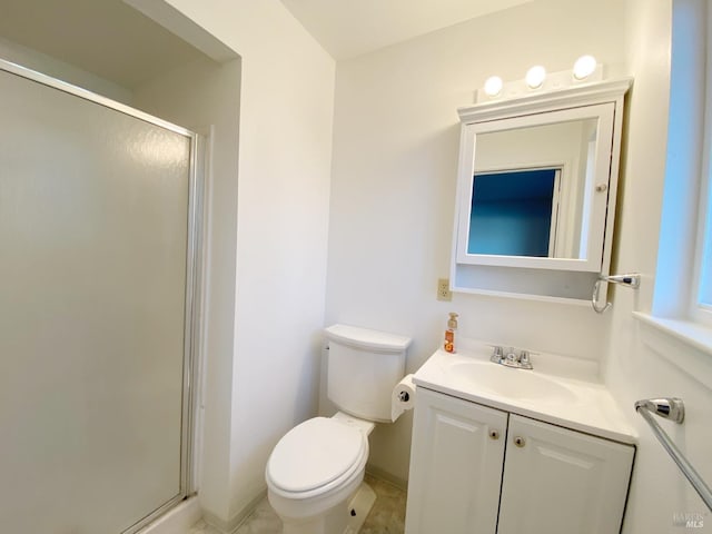 bathroom with a shower with door, vanity, and toilet