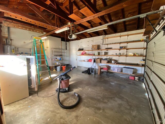 garage featuring a garage door opener and electric water heater