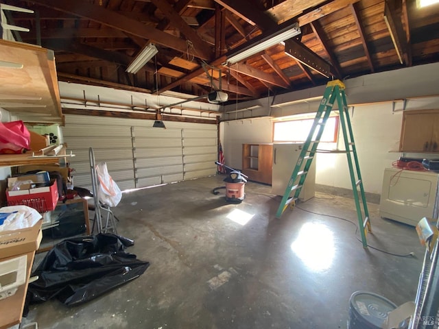 garage featuring a garage door opener and washer / dryer