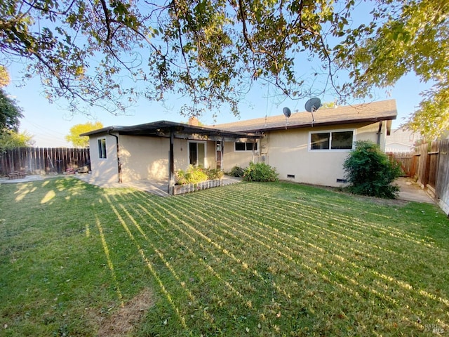 rear view of property with a yard