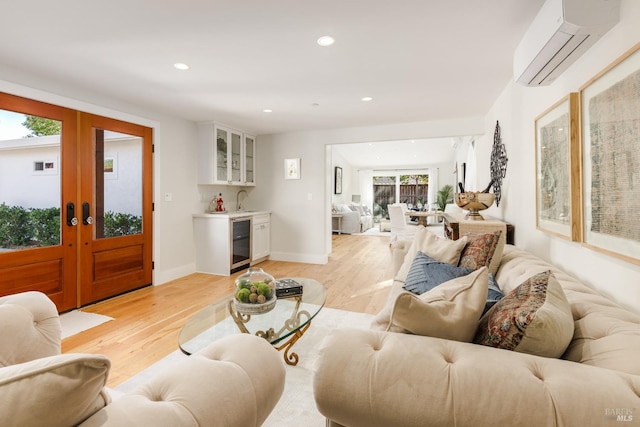 living room featuring french doors, a wealth of natural light, beverage cooler, and indoor wet bar