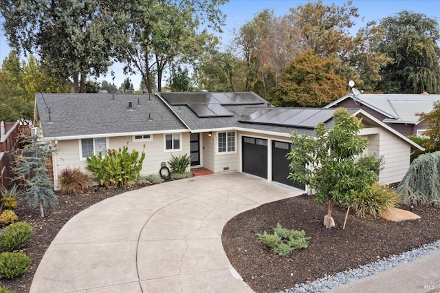 single story home featuring a garage and solar panels