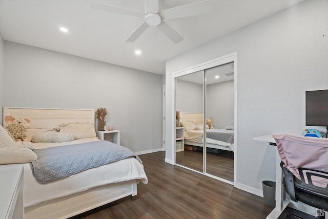 bedroom with dark hardwood / wood-style flooring, a closet, and ceiling fan