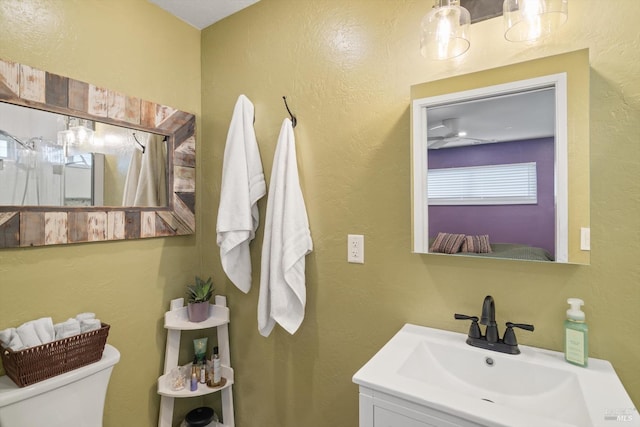 bathroom featuring ceiling fan, vanity, and toilet