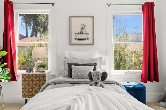 bedroom with carpet flooring and multiple windows