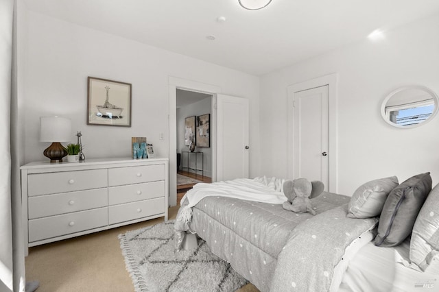 bedroom featuring light carpet