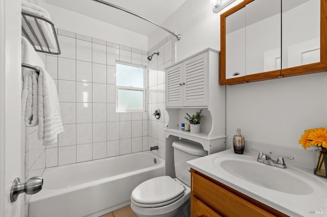 full bathroom featuring tiled shower / bath, vanity, and toilet