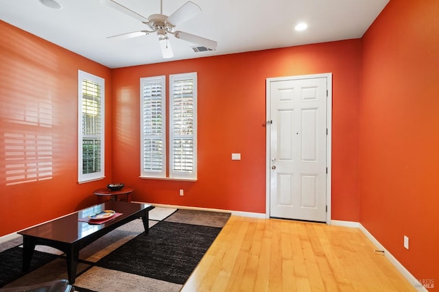 entrance foyer featuring wood-type flooring and ceiling fan