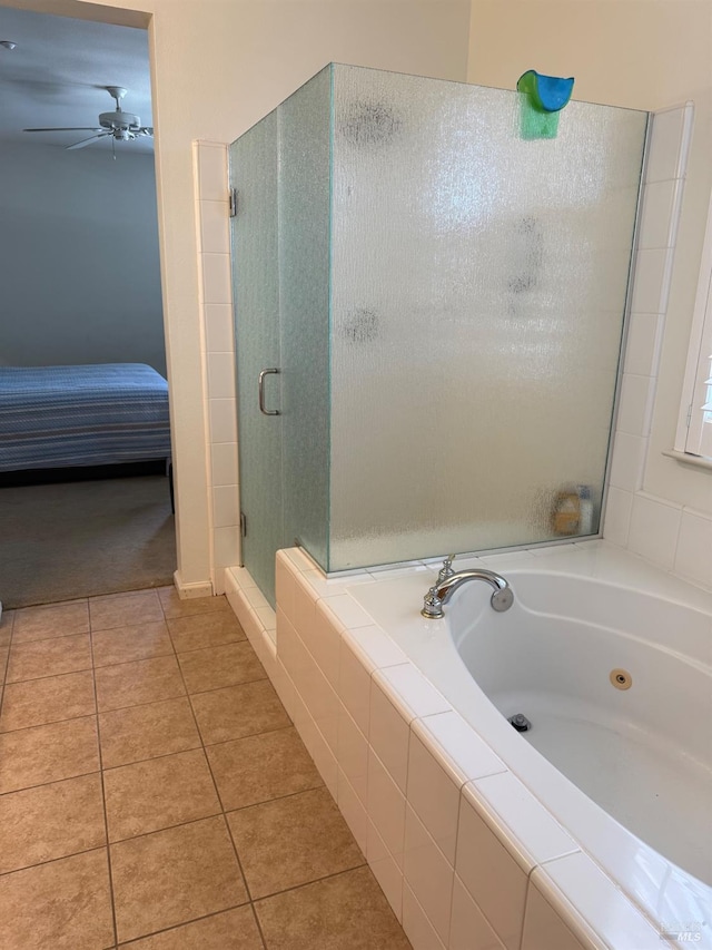 ensuite bathroom featuring tile patterned floors, a shower stall, a tub with jets, and a ceiling fan
