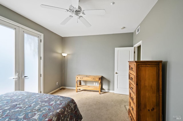 bedroom featuring french doors, light carpet, and ceiling fan